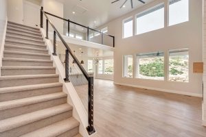 Stairs with railing and big windows